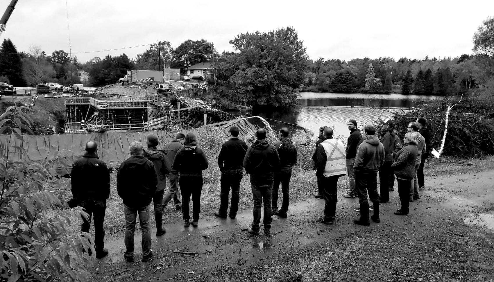 Halifax Water employees and Water Research Foundation employees looking at lake