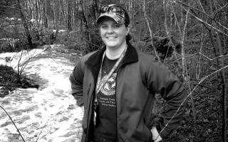 Halifax Water employee Kara, standing beside a river in the minicipality