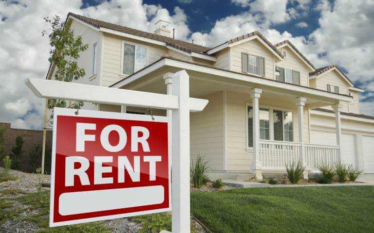 House with "For Rent" sign on front lawn.