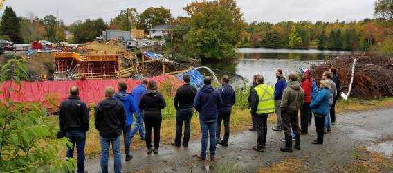 Halifax Water employees and Water Research Foundation employees looking at lake